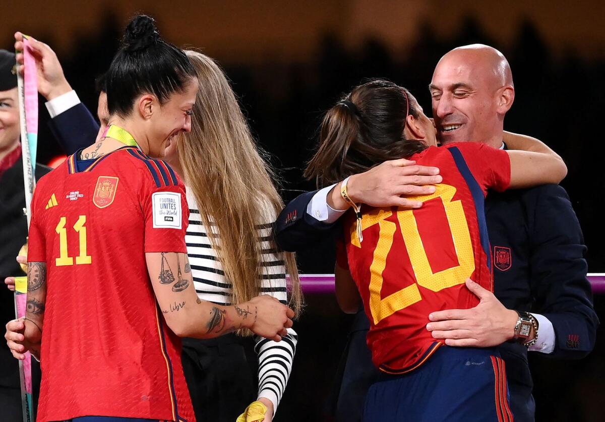 Spain defender (20) Rocio Galvez is congratulated by President of the Royal Spanish Football Federation, Luis Rubiales as Jennifer Hermoso (11) looks on after Spain won the Women's World Cup final against England in Sydney on August 20, 2023. — AFP