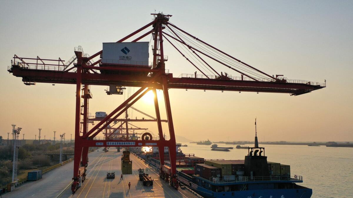 An image shows cranes and cargo ships at Nanjing port in China's eastern Jiangsu province. China's exports in December fell the most since 2020, according to official figures released on January 13, 2023, after health restrictions hit the economy hard.  — AFP