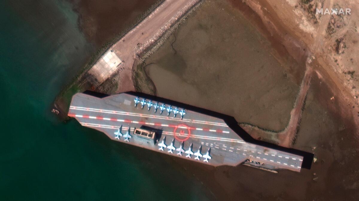 In this Feb. 15, 2020 satellite photo provided on July 27, 2020, by Maxar Technologies, a mockup aircraft carrier built by Iran is seen at Bandar Abbas, Iran, before being put to sea. Satellite photographs released on Monday, July 27, showed Iran has moved the aircraft carrier out to sea likely for naval drills amid heightened tensions between Tehran and the U.S. Photo: AP