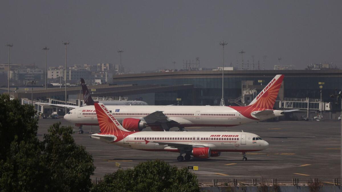 Air India passenger aircraft are seen on the tarmac at Chhatrapati Shivaji International airport in Mumbai on February 14, 2023. The deal is expected to also include an order for 220 planes from Airbus rival Boeing, according to Reuters.
