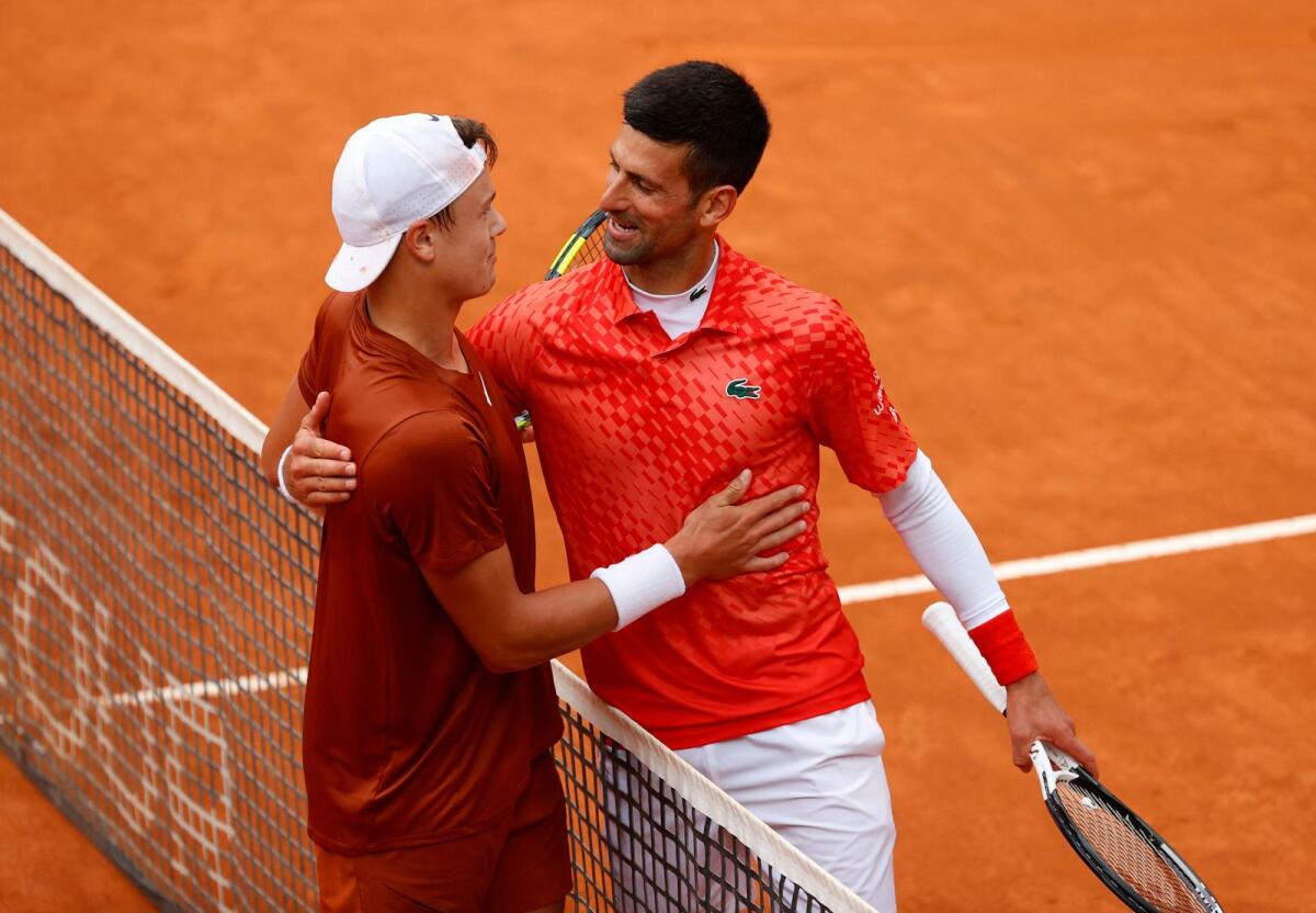 Denmark's Holger Rune with Serbia's Novak Djokovic after winning his quarter final match. Photo: Reuters