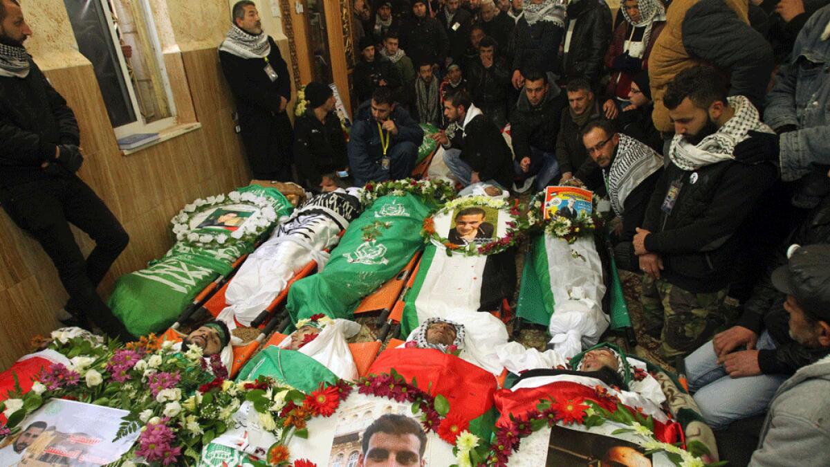 Mourners attend the funeral of fourteen Palestinians killed during recent attacks on Israelis.