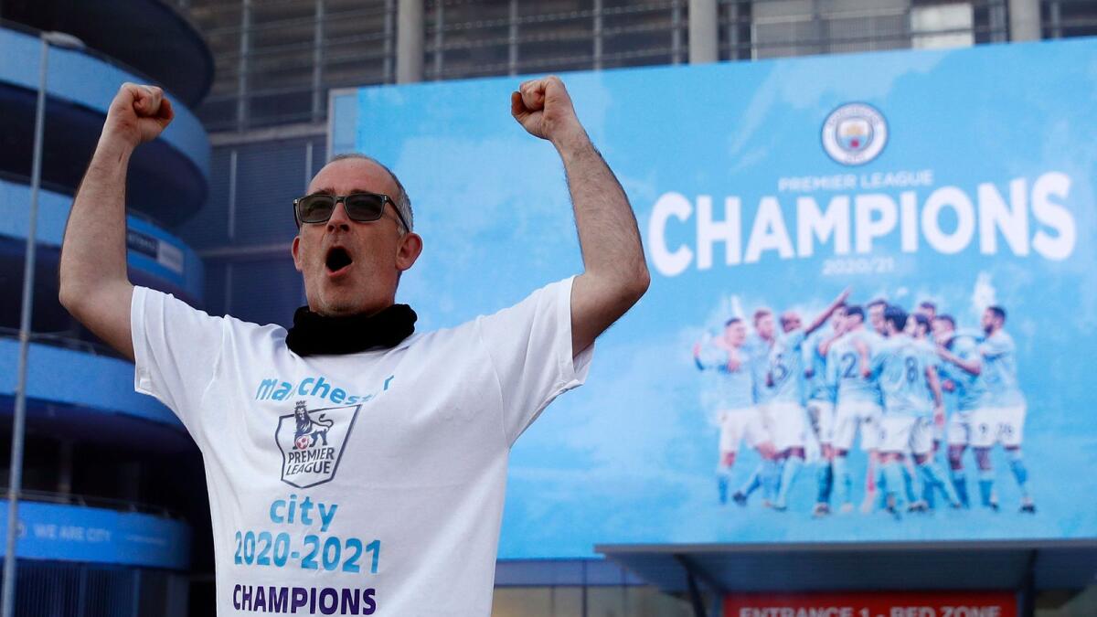 A Manchester City fan celebrates after the team’sPremier League triumph on Tuesday. (Reuters)
