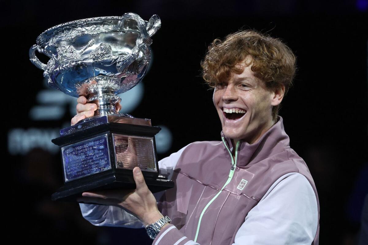 Italy's Jannik Sinner celebrates with the Norman Brookes Challenge Cup trophy after defeating Russia's Daniil Medvedev in the men's singles final at the Australian Open in Melbourne on Sunday. - AFP