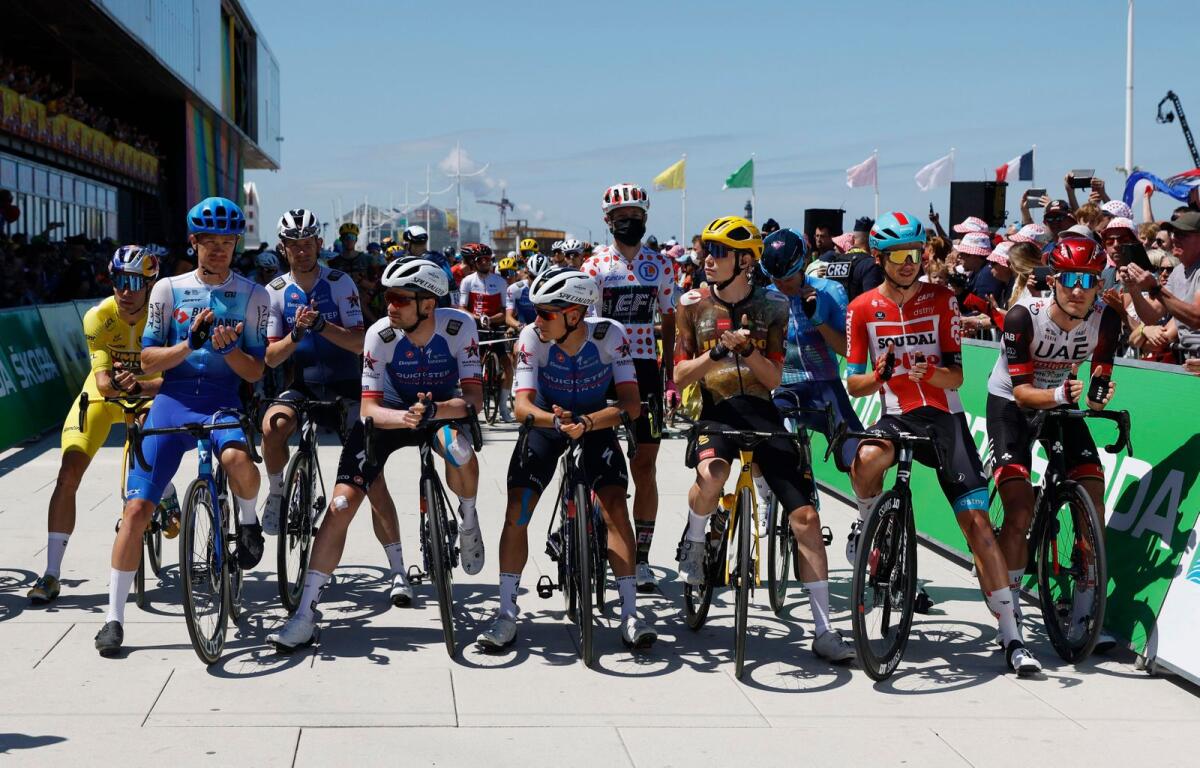 Tour de France riders during a minute of applause in remembrance of the Copenhagen shooting victims. (Reuters)