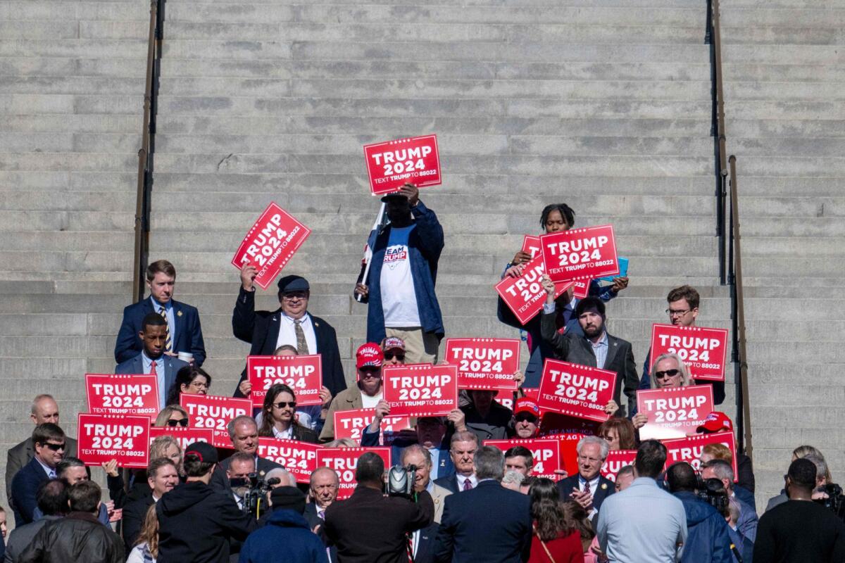 Supporters of former US president and presidential hopeful Donald Trump stand on the steps during a press conference at the South Carolina State House in Columbia, South Carolina, on February 1, 2024.  — AFP