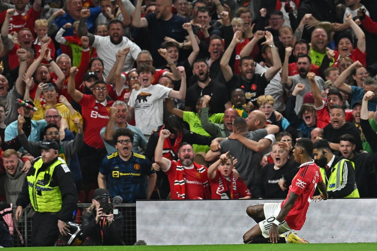 Manchester United striker Marcus Rashford celebrates in front of supporters after scoring their second goal. (AFP)
