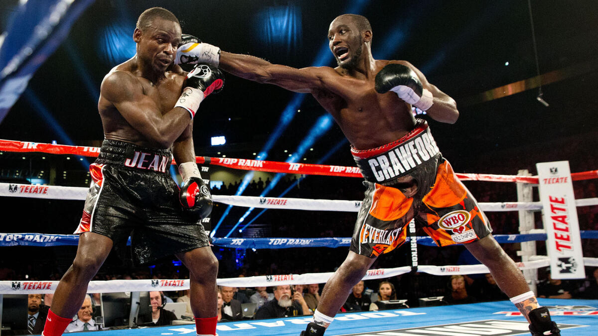 Terence Crawford (right) punches Dierry Jean during a WBO junior welterweight title fight. 