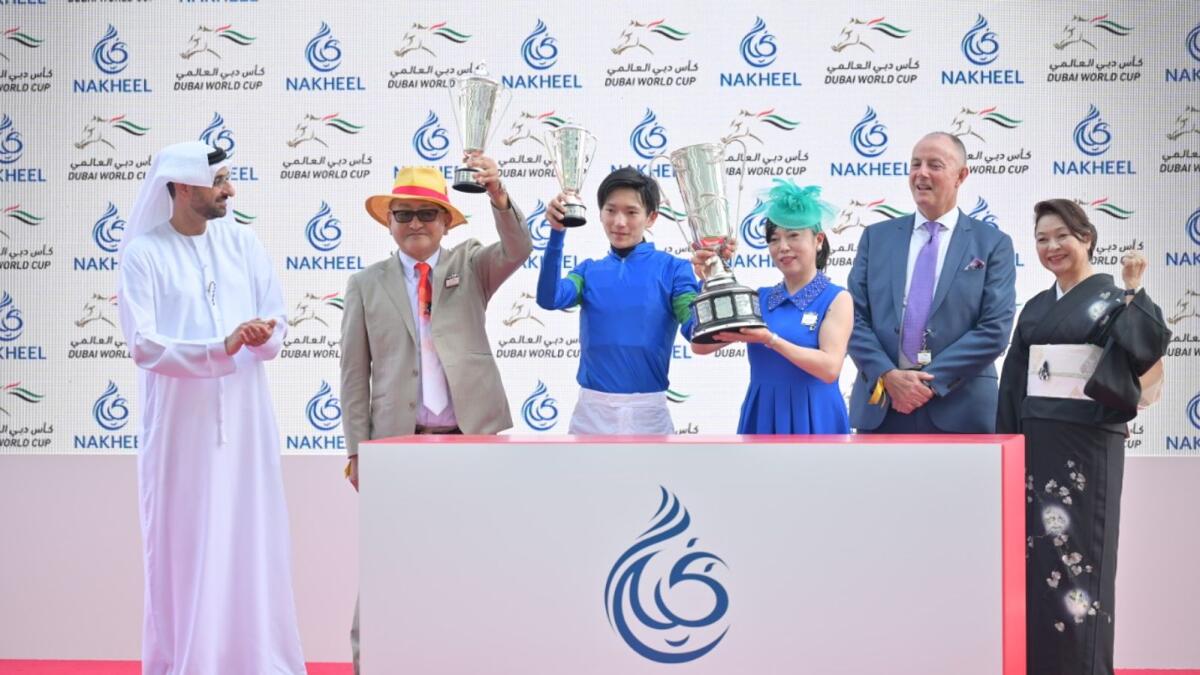 Owners of horse BATHRAT LEON (JPN) and jockey Ryusei Sakai pose with trophy during the presentation of Godolphin Mile Sponsored By Nakheel race of Dubai Word Cup at Meydan on Saturday, March 26. Photo by Rahul Gajjar