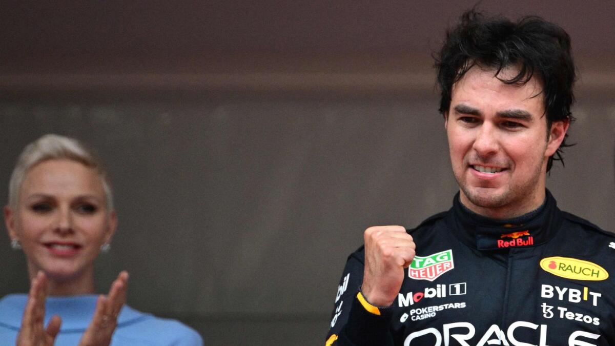 Red Bull's Sergio Perez celebrates on the podium after winning  the Monaco Grand Prix. — AFP