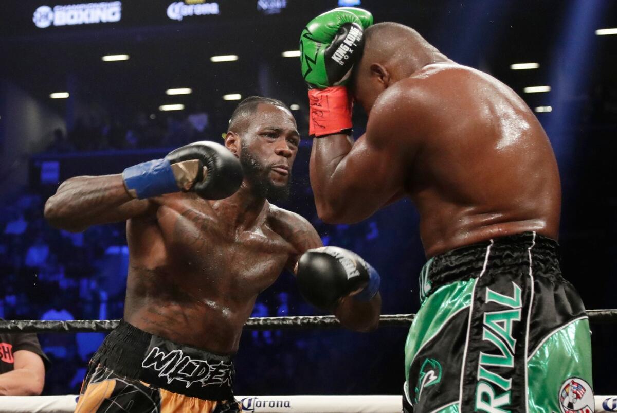 Deontay Wilder (L) in action against Luis Ortiz during the third round of the WBC heavyweight championship bout in New York.  Wilder wins by seventh-round knockout. - AP