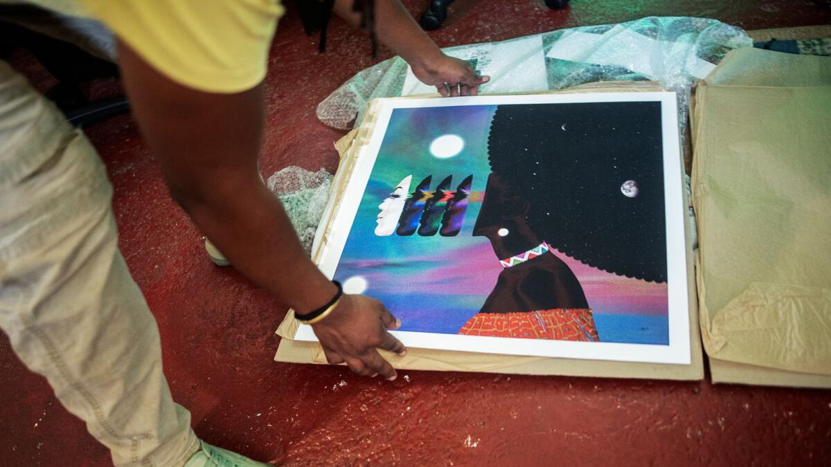 Visual artist vonMash checks a fine art print from his last exhibition at his studio in Springs, South Africa, on February 7, 2022. Photo: AFP