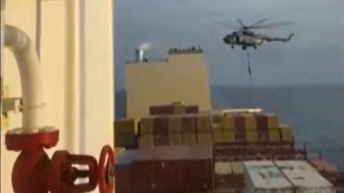 This image grab taken from a UGC video posted on social media on April 13 shows Iran's Revolutionary Guards rappelling down onto a container ship named, MSC Aries, near the Strait of Hormuz. Photo: AFP file