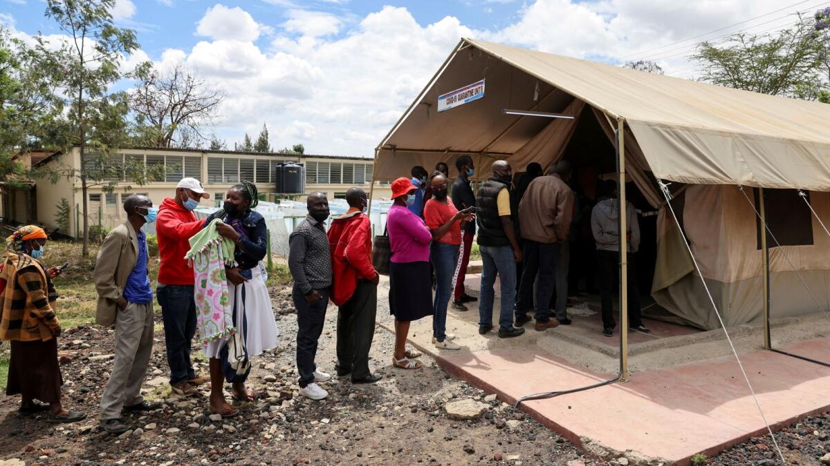 People stand in line to receive a Covid vaccine in Kenya - Reuters file