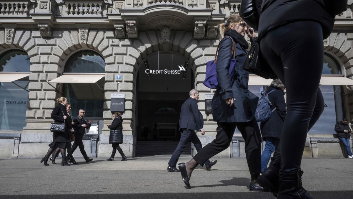 People walk past the entrance of Swiss bank Credit Suisse at their headquarters in Zurich, Switzerland. - AP