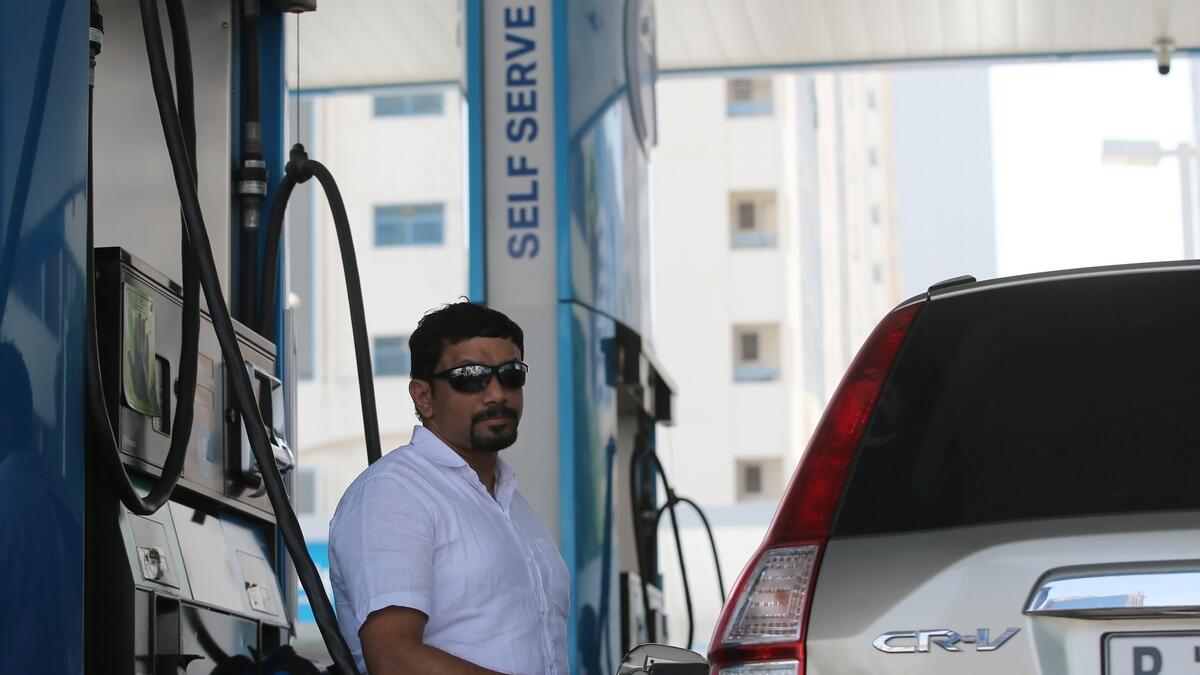 Motorist tries the new flex service at Adnoc stations which includes the self-service option.-Photo By Ryan Lim