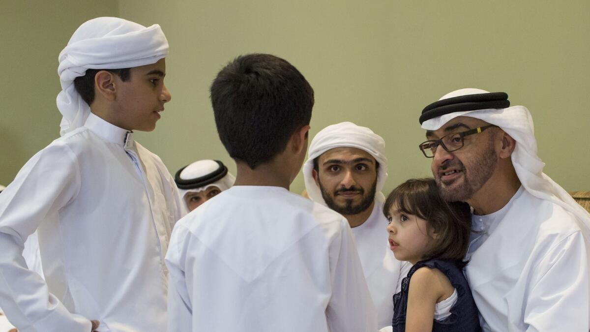 His Highness Shaikh Mohammed bin Zayed Al Nahyan, Crown Prince of Abu Dhabi and Deputy Supreme Commander of the UAE Armed Forces, talking to family members of martyr Ahmad Ghulam Abdul Karim Lingawi in the Nouf area of Sharjah on Sunday. — Wam