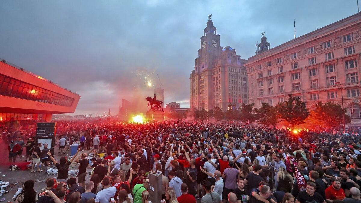 Liverpool fans let off flares outside the Liver Building in Liverpool