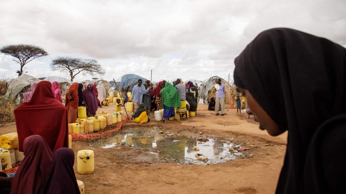 Somali refugees put water containers for the water distribution by French charity Doctors Without Borders (MSF) in the Dadaab refugee camp, one of Africa's largest refugee camps in Kenya, on March 23, 2023. — AFP
