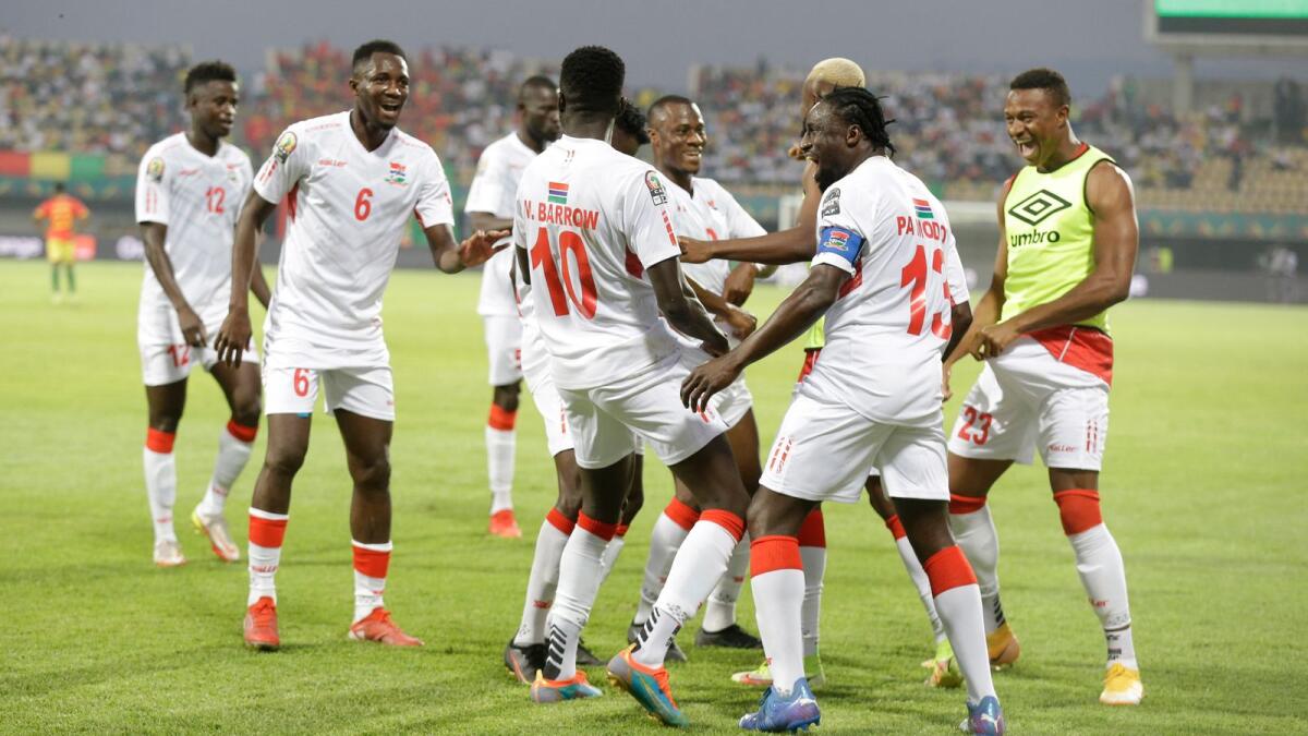 Gambia's Musa Barrow celebrates with teammates after scoring against Guinea. (AP)