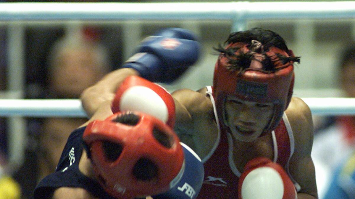 India's Ng-Dingko Singh (right) punches Timur Tulyakov (left) of Uzbekistan during the bantamweight boxing final at the 1998 Asian Games in Bangkok. Singh won the gold when Tulyakov retired after the fourth round. (AFP file)