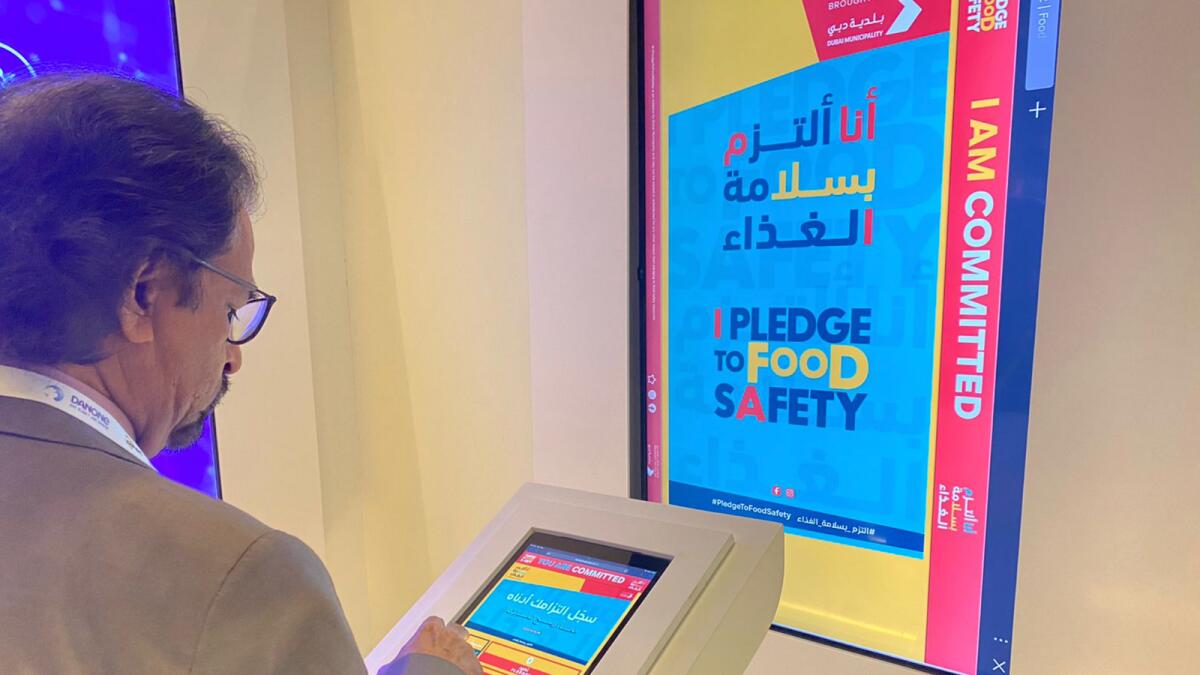Officer signs pledge to handle food safely at DIFSC in Dubai.  - Image provided
