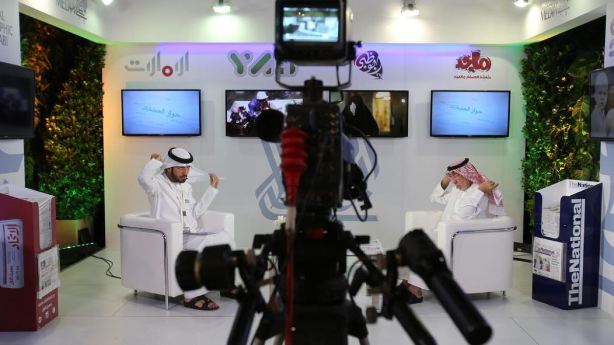 An Emirati television anchor and his guest prepare for a programme at the Arab Media Forum in Dubai