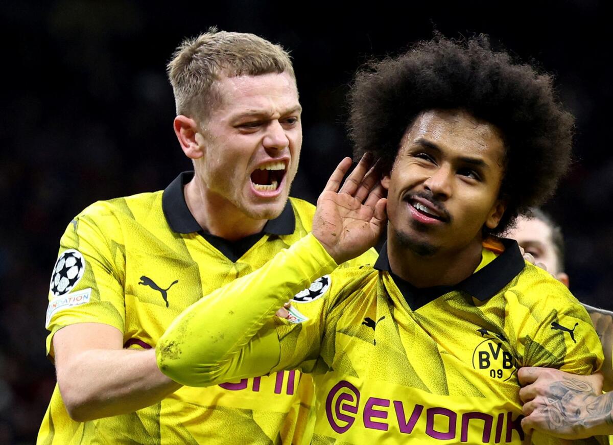 Borussia Dortmund's Karim Adeyemi celebrates with Julian Ryerson after scoring a goal. — Reuters