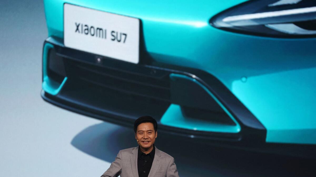 Xiaomi founder and CEO Lei Jun speaks at an event on the company's first electric vehicle, the SU7, in Beijing on Thursday. — Reuters