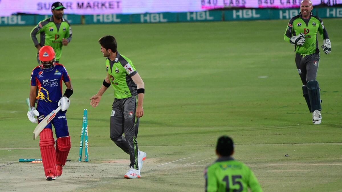 Karachi Kings' Babar Azam (front left) is bowled by Lahore Qalandars' Shaheen Afridi (centre) during the PSL match in Karachi. — AFP