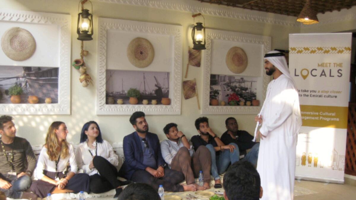 An Emirati man interacts with visitors at a session of Meet the Locals. — Supplied photo