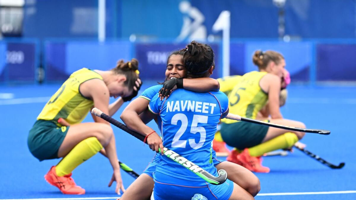 India's Neha (left) and Navneet Kaur celebrate after defeating Australia in the women's quarterfinal at the Tokyo Olympics. (AFP)