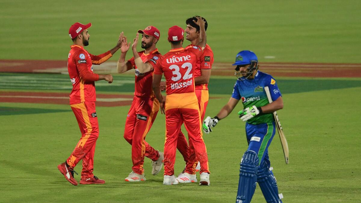 Islamabad United's players celebrate the wicket of Multan Sultan's Shahid Afridi during the Pakistan Super League match at the National Stadium in Karachi.— AFP