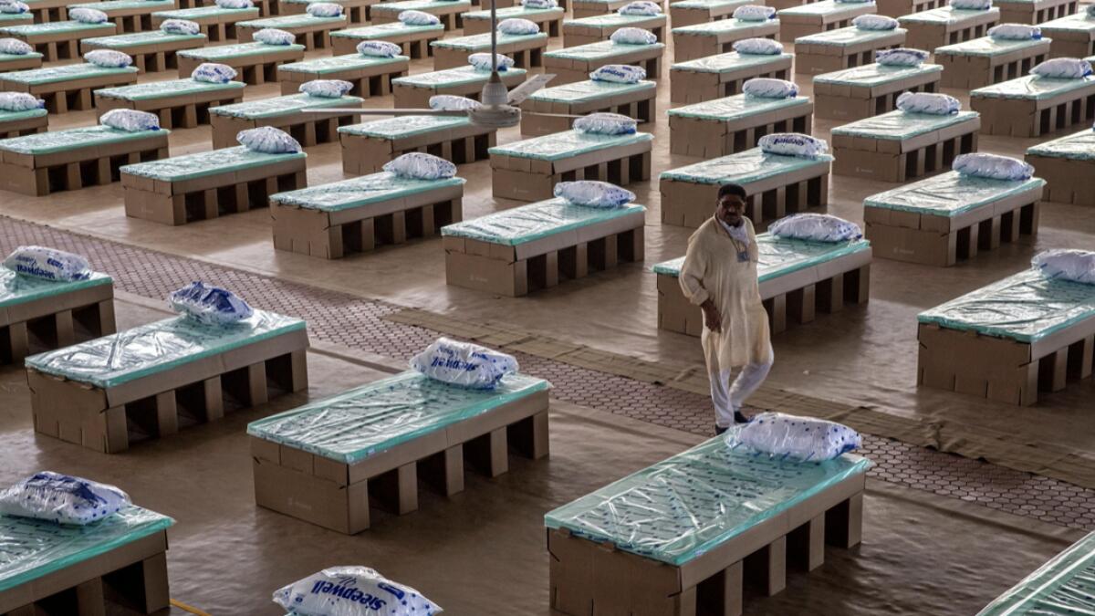 A volunteer walks past disposable beds made out of cardboard at the campus of Radha Soami Satsang Beas, a spiritual organization, where a coronavirus disease (Covid-19) care centre has been constructed for the patients amidst the spread of the disease, in New Delhi, India. Photo: Reuters