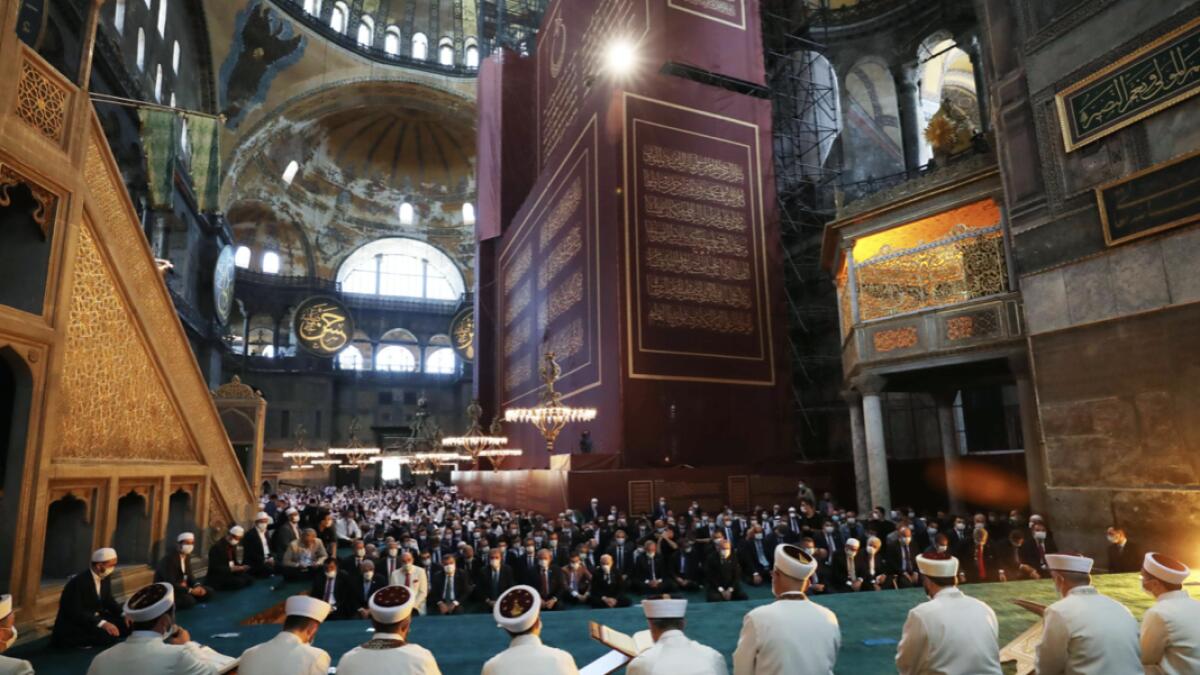A handout picture taken and released by the Turkish Presidential Press service shows Turkey's President Tayyip Erdogan (C) and invited guests attending Friday prayers at Hagia Sophia Grand Mosque during the official opening ceremony of Hagia Sophia in Istanbul, Turkey. Photo: AFP