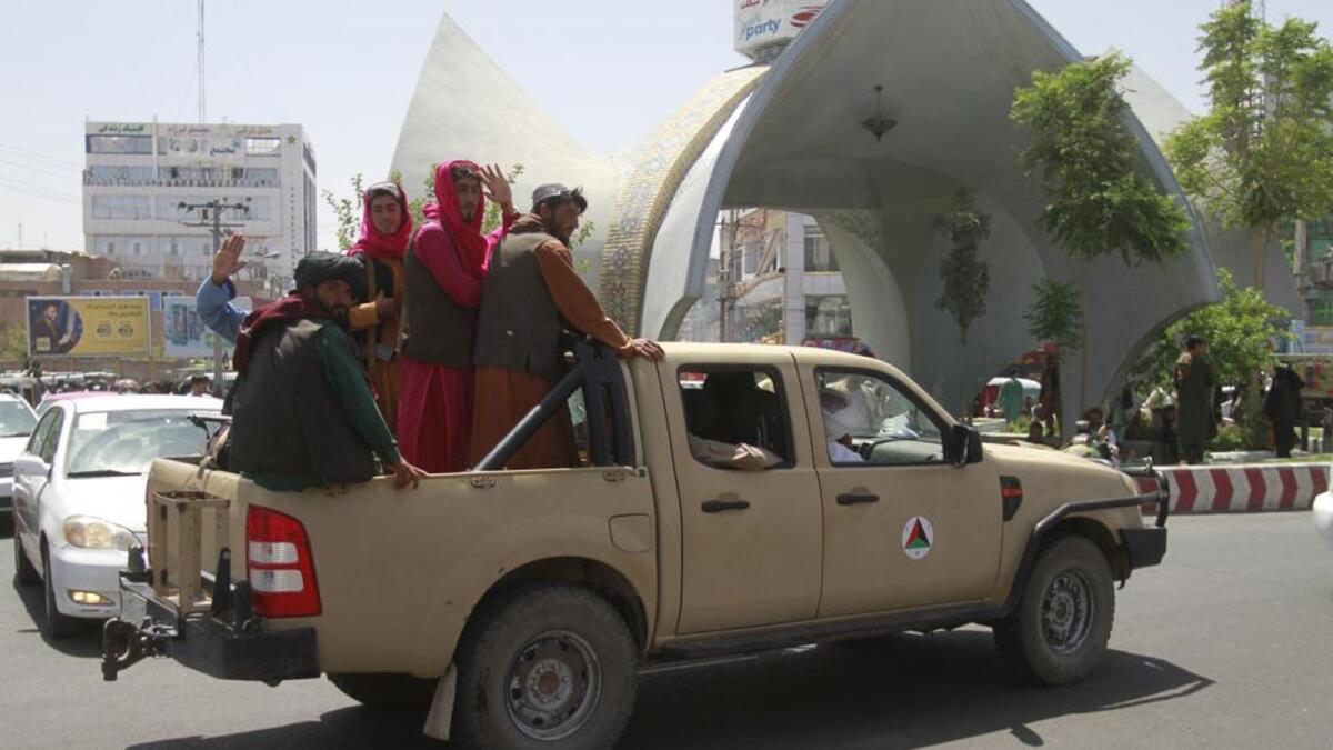 Taliban fighters pose on the back of a vehicle in the city of Herat, west of Kabul. Photo: AP