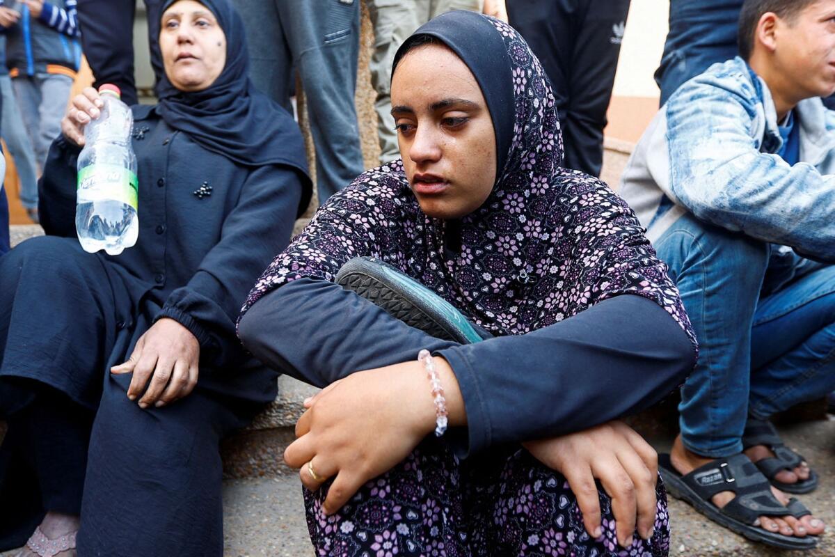 Razan Ashram holds her husband's shoes, who was killed in an Israeli raid. Photo: Reuters