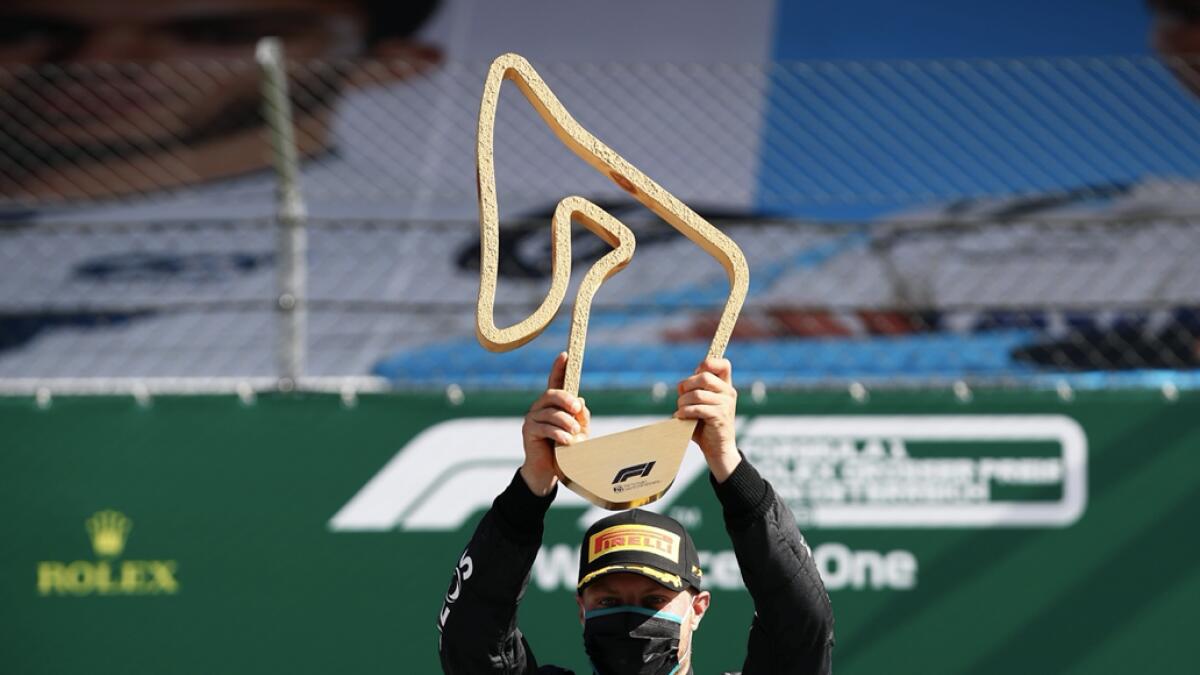Mercedes' Valtteri Bottas celebrates with the trophy on the podium after winning the race, as F1 resumes following the outbreak of the coronavirus disease (Covid-19). Photo: Reuters