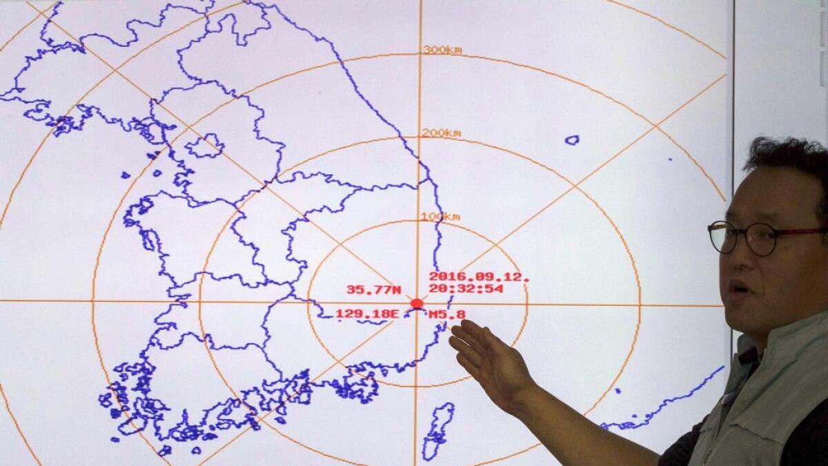 A South Korean official points to a map showing the epicenter seismic waves after an earthquake at the Korea Meteorological Administration in Seoul on September 9, 2016.