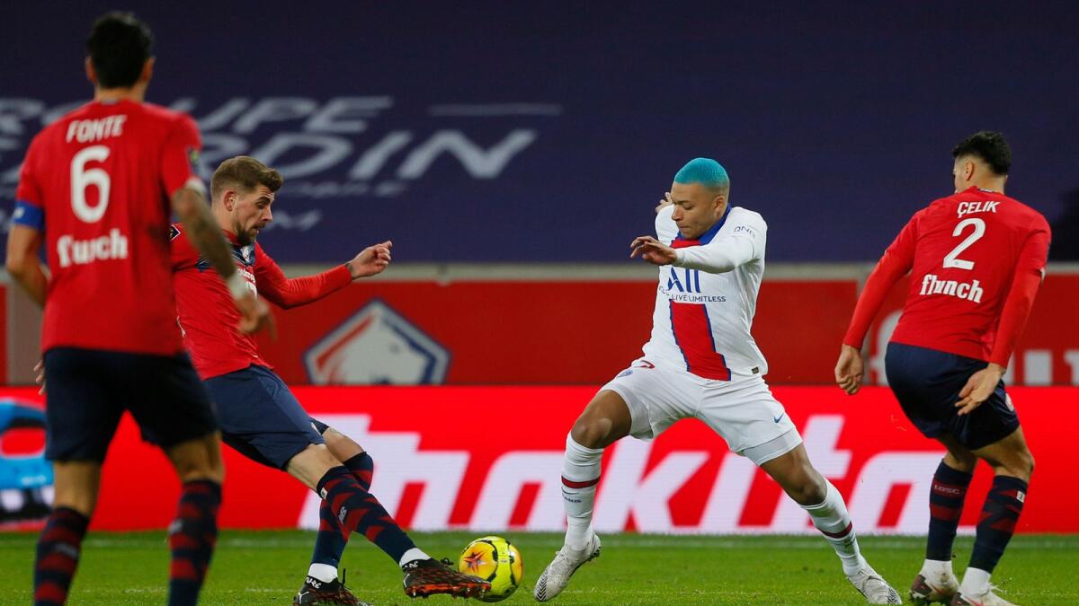 PSG's Kylian Mbappe (centre) in action during the French League One match against Lille. — AP