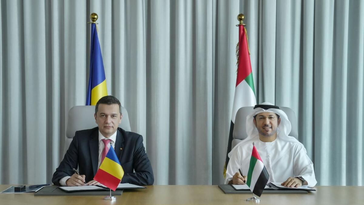 Sorin Mihai Grindeanu, Romania’s Minister of Transport and Infrastructure, and Abdulla bin Damithan, CEO and managing director, DP World UAE, and vice-chairman of PCFC’s board of directors, signing the agrement. — Supplied photo