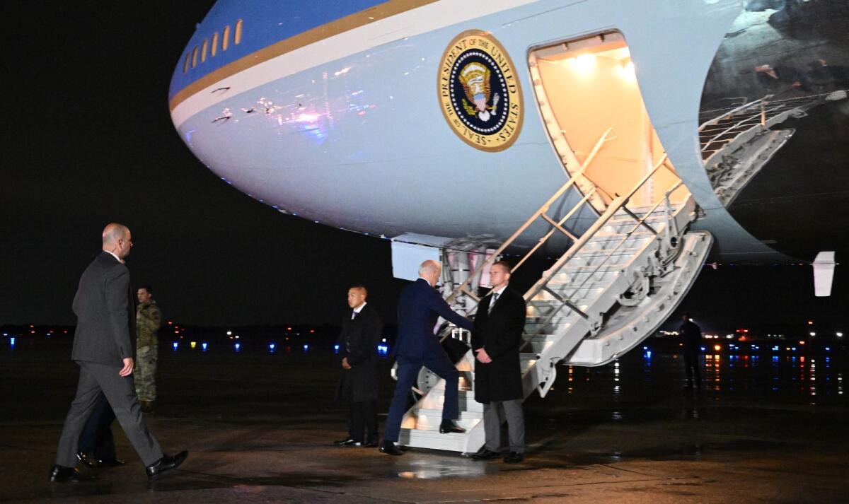 US President Joe Biden makes his way to board Air Force One before departing from Andrews Air Force Base in Maryland on July 12, 2022. (Photo by AFP)