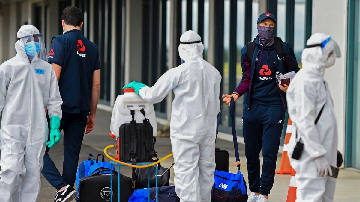 England's captain Joe Root (second right) arrives at the Rajapaksa international airport in Mattala. — AFP
