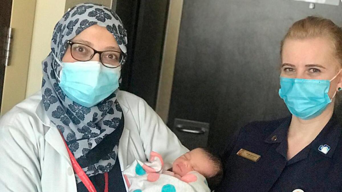 baby in car, woman delivers baby, Al Zahra hospital, childbirth, Sharjah, parking lot