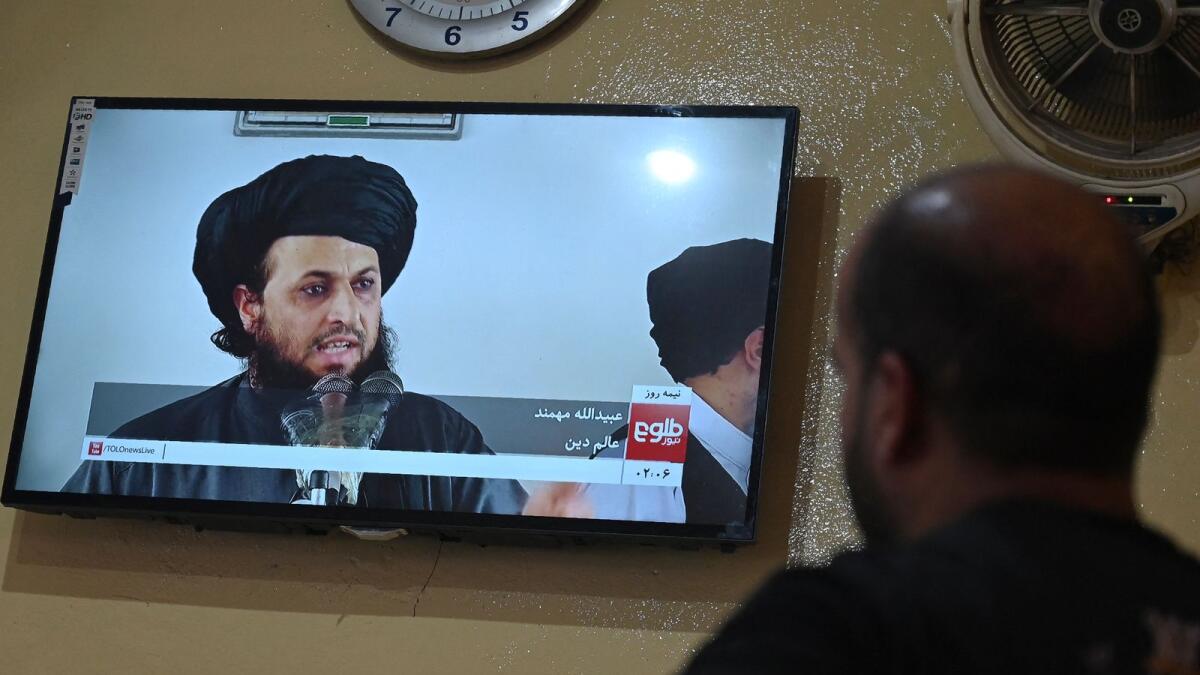 A man watches a live television broadcast of the Tolo News channel in Kabul. Photo: AFP