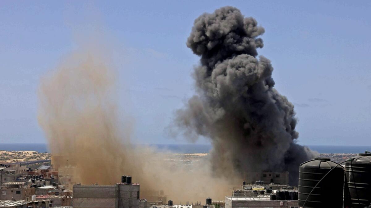Smoke billows from a building targeted during an Israeli air strike in Rafah in the southern Gaza Strip on Thursday. —AFP