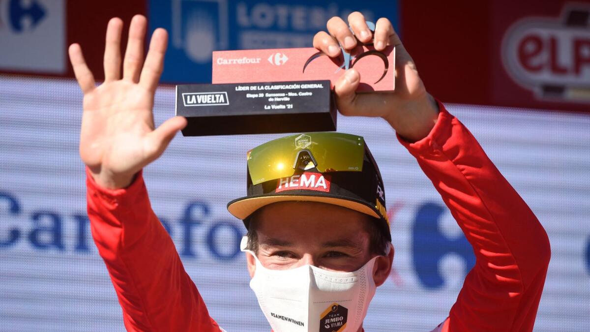 Team Jumbo's Slovenian rider Primoz Roglic celebrates on the podium as he retains the overall leader's red jersey after the 20th stage of the 2021 La Vuelta cycling tour of Spain. — AFP