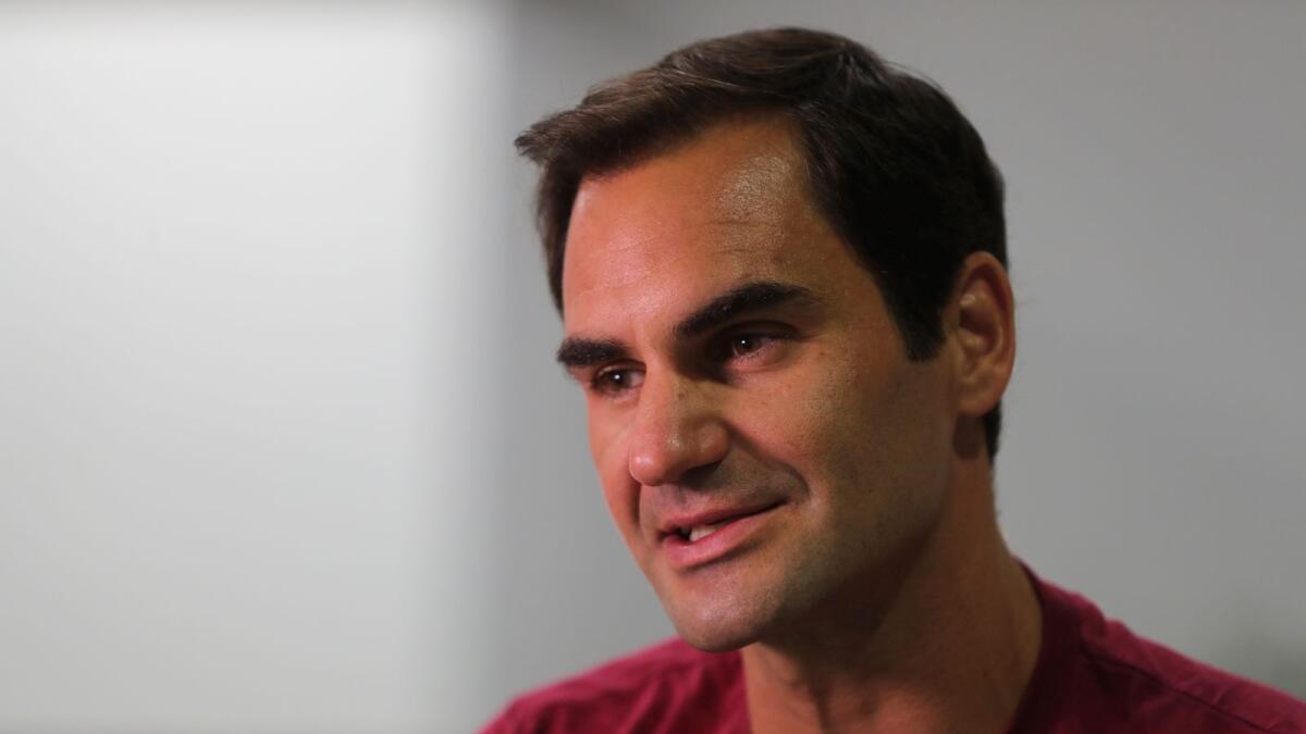 Roger Federer talks to media in Dubai. — AP
