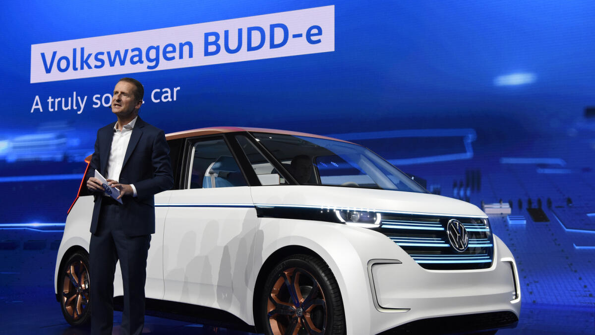 Herbert Diess, head of the VW brand and member of the board of management at Volkswagen AG, stands beside the BUDD-e long-distance electric vehicle (EV) during an unveiling event at the 2016 Consumer Electronics Show (CES) in Las Vegas, Nevada.