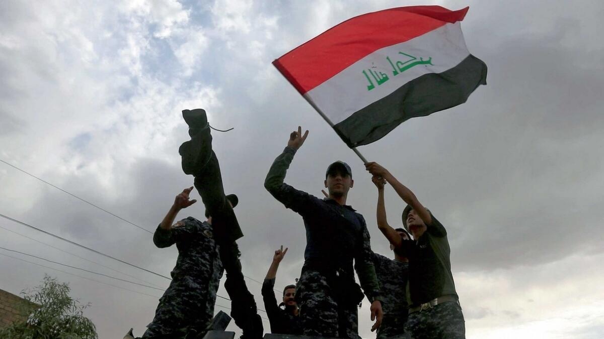 LET THE PARTY BEGIN: Iraqi forces rejoicing in the Old City of Mosul on Saturday. 